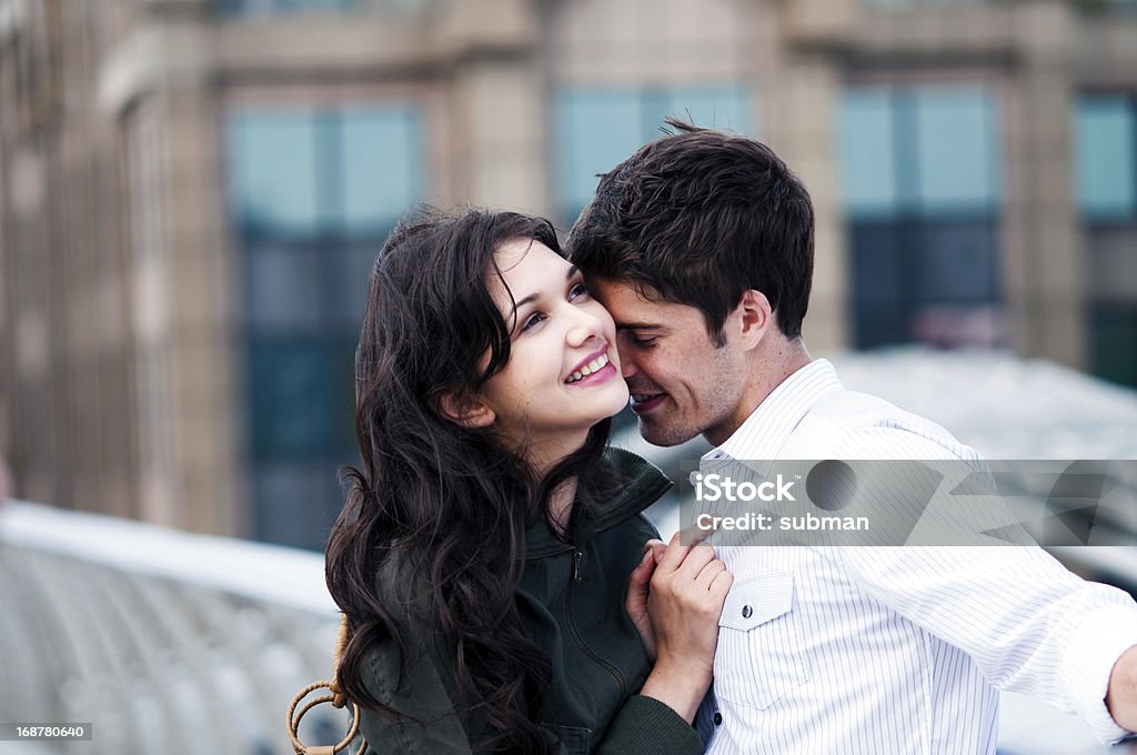 Young couple being in love on bridge Young couple being in love, standing on a bridge. 20-24 Years Stock Photo