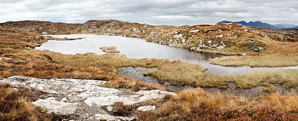 Small mountain lake in the Scottish Highlands, in the hiking area near Lochinver.