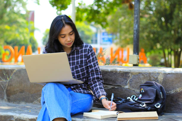 istock young smiling asian woman using laptop and writing notebook, cheerful asian student watching webinar and studying from e course 1687872194