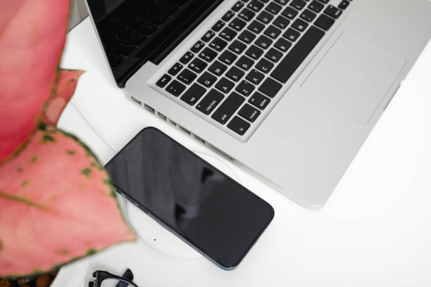 istock Charging smartphone battery with wireless charger device 1687877780