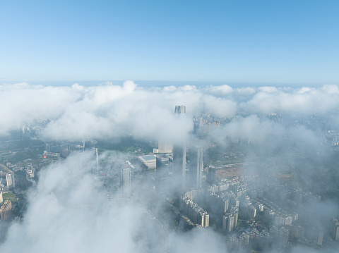 City high-rise buildings in clouds and fog