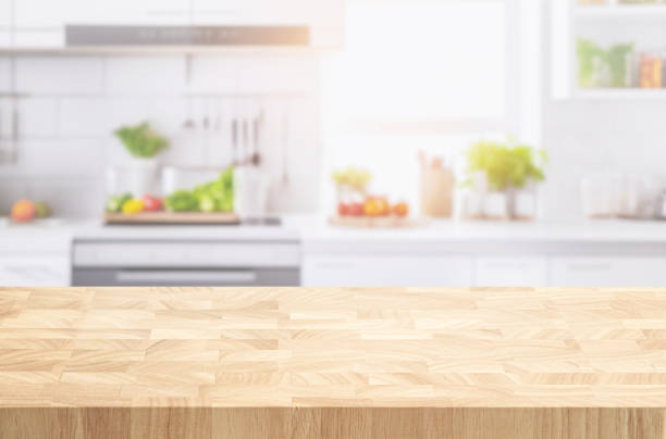 istock Selective focus.End grain wood counter,table top on blur kitchen counter in morning background. 1687897103