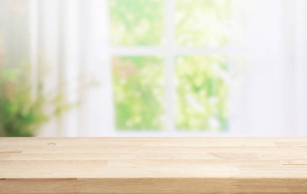 istock Selective focus.Wood table counter on blur curtain window in morning background 1687897169