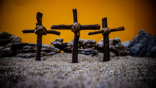 istock crosses stuck in the sand on an orange background 1687897378