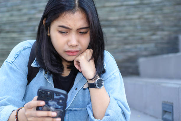 istock shocked asian young woman traveler while using mobile application on smartphone, browsing social media, and watching video in urban outdoor 1687897398