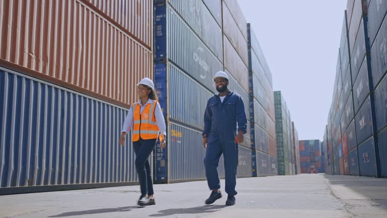 Engineer Working at Containers In Shipping Dock.