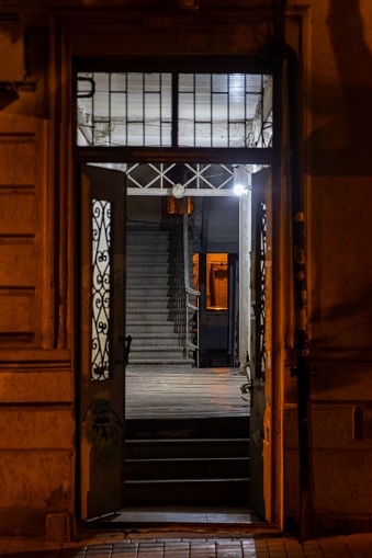 An open door reveals a dark and mysterious hallway in Vere, Mtatsminda District, Tbilisi, Georgia