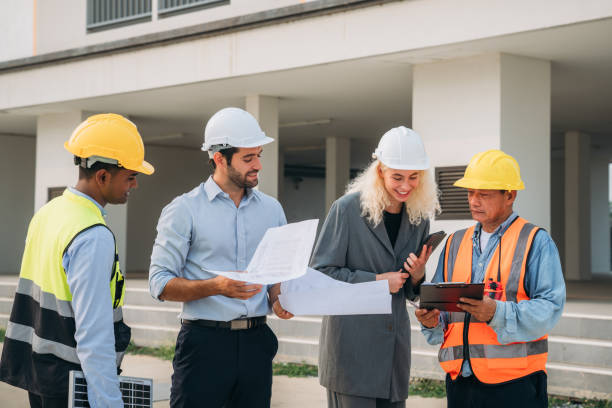 istock Team construction workers discussing project details. Professional Construction Team Meeting for Project Development. 1687899686