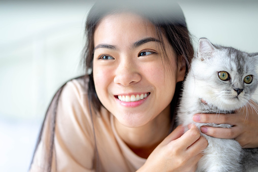 Woman at home holding and hug her lovely fluffy cat. lifestyle concept. Friend of human. Pets and lifestyle concept.