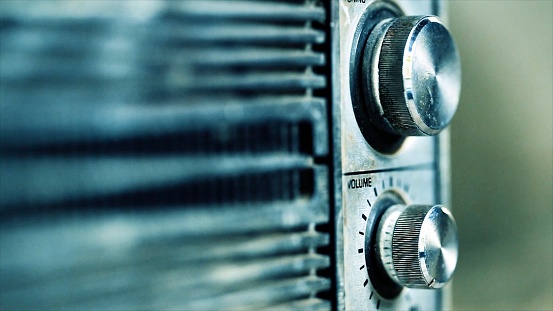 Close-up of a radio. Old radio with blurred background. Old radio on blurred rustic background in vintage colors