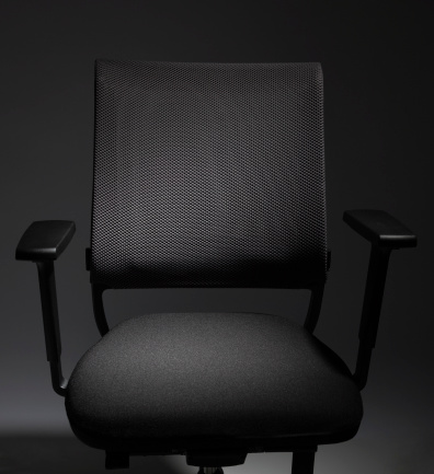 Dark office chair with selective lighting