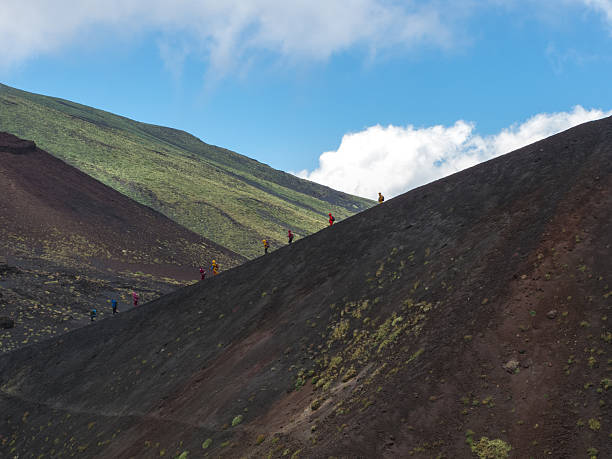 istock Trekking people in windsuits a lane descending 168793712