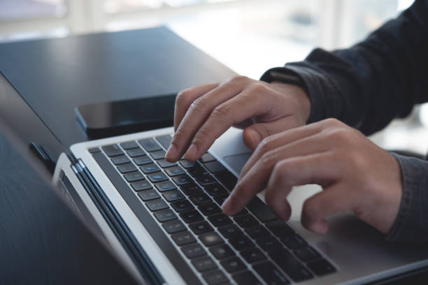 istock Business man hands typing on laptop computer keyboard and surfing the internet on office table, online working, business and technology, internet network communication concept, close up 1687957960