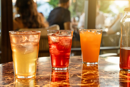 cold fruit-flavored iced drinks. Iced fruit-flavored drinks on the table in the cafe