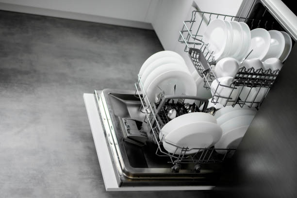 istock Built-in dishwasher. Clean dishes in the dishwasher. A clean white utensil. Modern technologies in the kitchen. Modern home kitchen. Housework 1687998294
