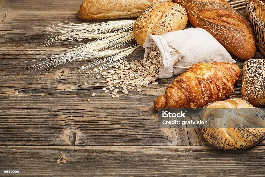 Different types of bread Different types of baked goods on wooden background Baked Pastry Item Stock Photo