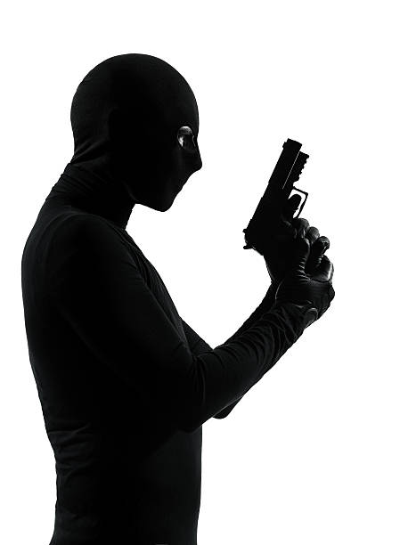 istock thief criminal terrorist holding gun portrait 168800806