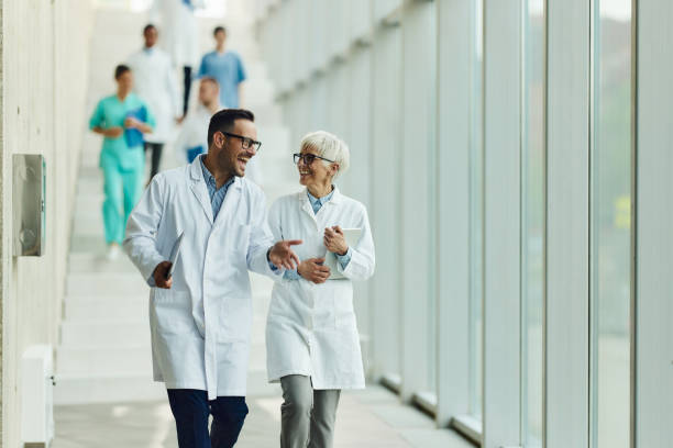 istock Happy doctors talking while walking through hallway of a hospital. 1688009626