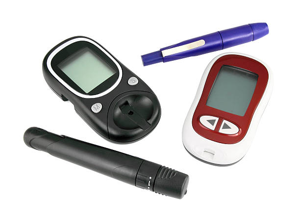 白い背景の上の 2 つの glucometer - glucose blood care white ストックフォトと画像