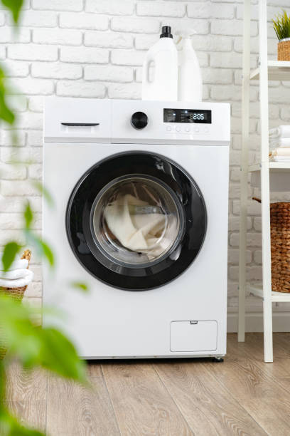 istock Detergent bottle on washing machine in a laundry room 1688011929