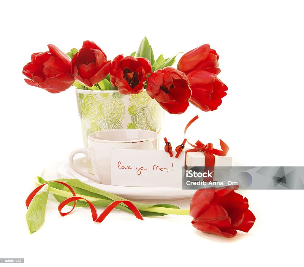 Fresh tulip flowers with morning coffee Photo of fresh red tulip flowers in vase and cup of coffee isolated on white background, morning beverage for dear mom, greeting postcard, mothers day, still life, gift box, love concept Banquet Stock Photo