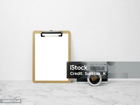 istock Paper board mockup on marble floor with camera 1688027448