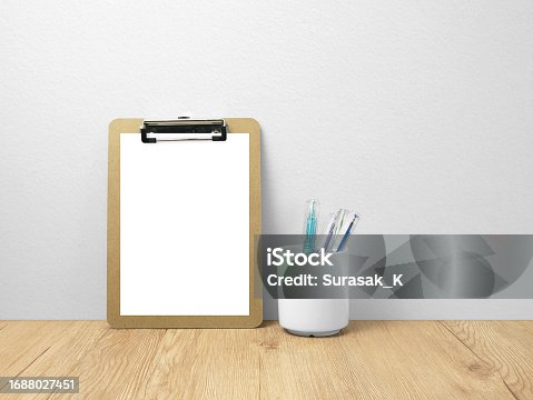 istock Paper board mockup on wooden floor with pen 1688027451