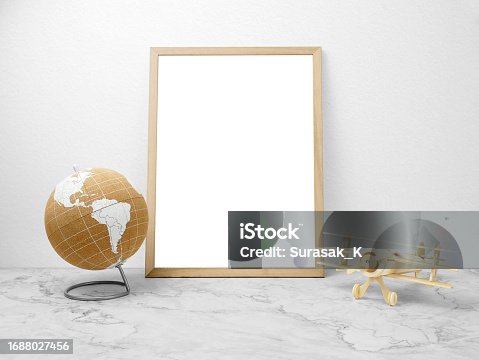 istock Blank frames mockup on marble floor with world and wooden plane 1688027456