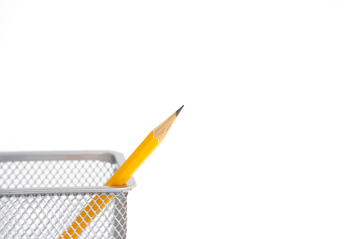 Pen holder full of pencils on isolated background