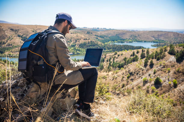 istock male hiker using laptop on rock 1688044599