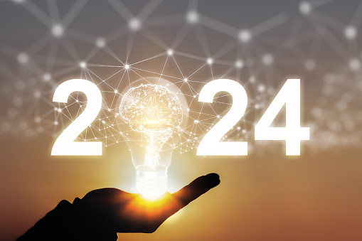 2024 Hand of businessman holding illuminated light bulb, New ideas, innovation and inspiration concepts.