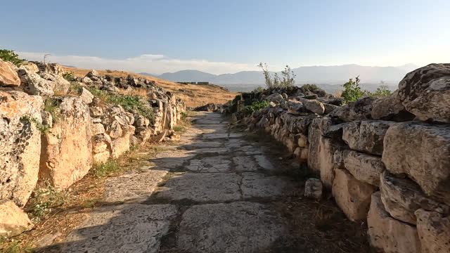 Walking in the streets of ancient ruins of Hierapolis during sunset in  Pamukkale in Denizli