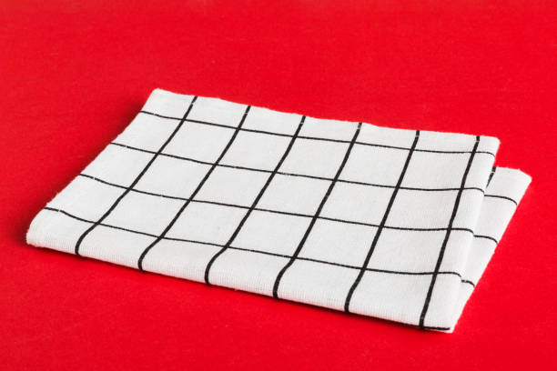 istock top view with white empty kitchen napkin isolated on table background. Folded cloth for mockup with copy space, Flat lay. Minimal style 1688069733