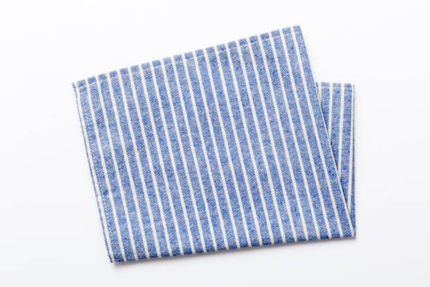 istock top view with blue kitchen napkin isolated on table background. Folded cloth for mockup with copy space, Flat lay. Minimal style 1688070300