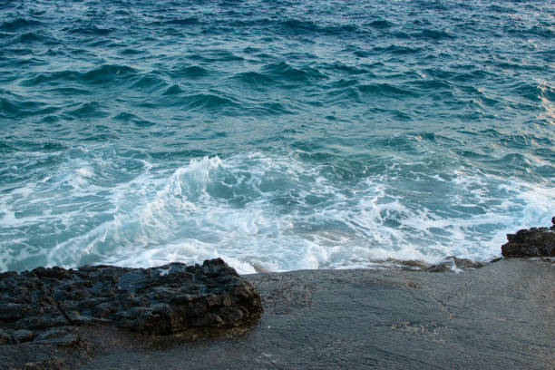 istock Sea waves break on a rocky beach, a coastline nature concept. 1688087829