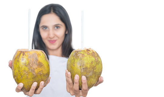 Young asian girl holding two fresh coconut water with straw Isolated on White Background, summer drink, dehydration - ImageYoung asian girl holding two fresh coconut water with straw Isolated on White Background, summer drink, dehydration - Image