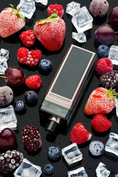 istock Electronic cigarette with berries and ice cubes on black background 1688090064