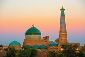 Minaret and madrasah of Islam-Khoja of the ancient city of Khiva at the sunrise, Uzbekistan.