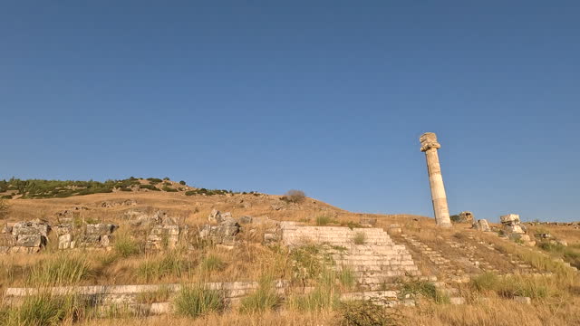 Walking in the agora of ancient ruins of Hierapolis during sunset in  Pamukkale in Denizli