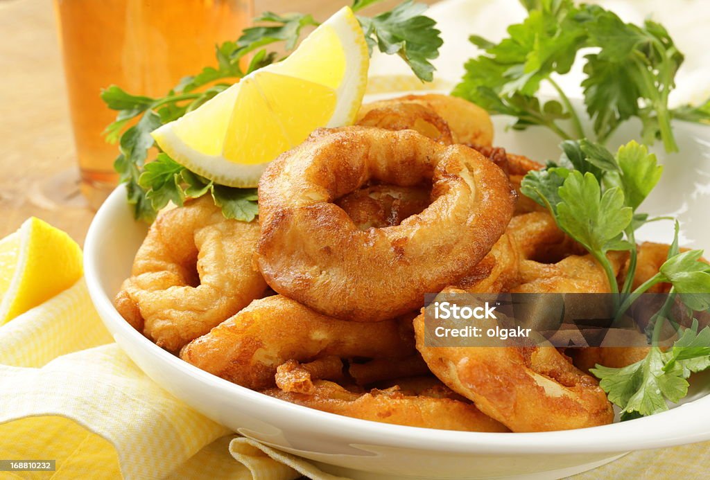 fried squid rings dipped in batter fried squid rings dipped in batter  with lemon Appetizer Stock Photo