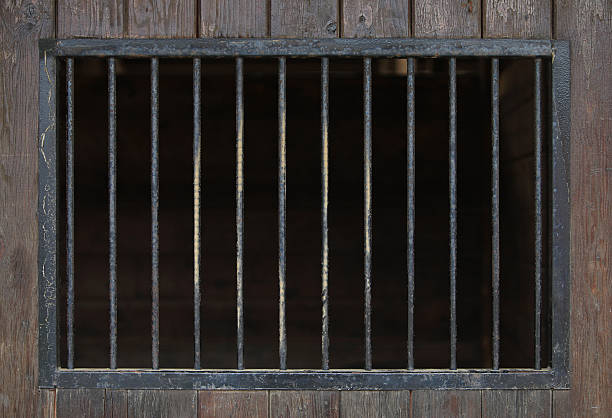 Close up of steel bars in a wooden building Old Metal Bars on Wooden Background. cage stock pictures, royalty-free photos & images