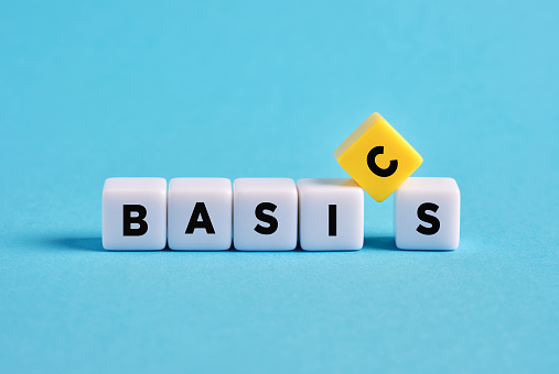 Back to basics. Simplifying business procedures. Essential or primary concepts and basis of education. Teaching the basics. The word basics on cubes.