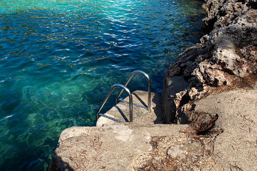 Pool ladder at one of the bays of Cala d'Or.