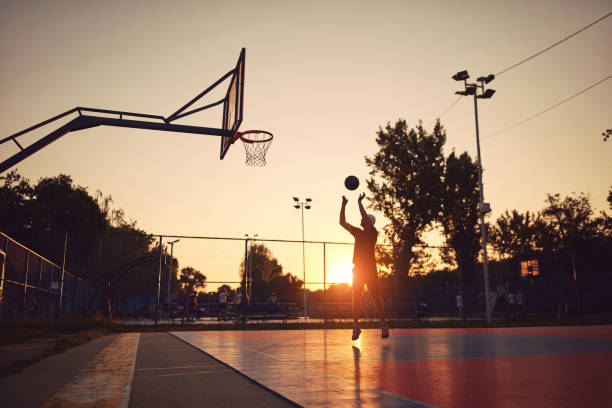istock Man playing basketball on a public court. 1688152207