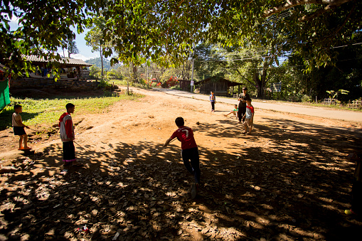 Chiang Mai, Thailand; 1st January 2023: A group of young people playing in the streets of a village in the mountains of Chiang Mai..