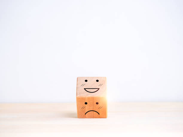 istock Customer service evaluation, feedback, and employee satisfaction survey concept. Flipping or turning of wooden cube block from sad face to happy smile emotion, isolated on white background with space. 1688194814