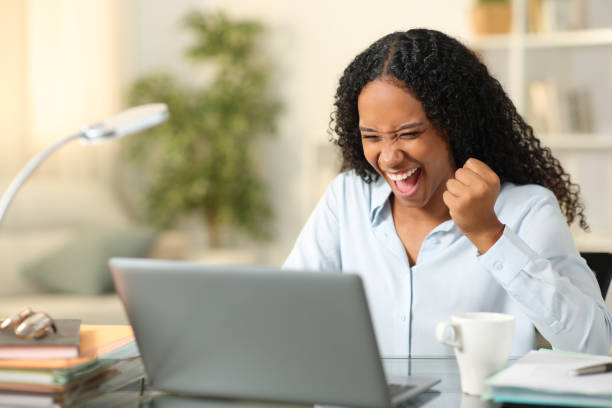 istock Excited black teleworker checking online news at home 1688198443