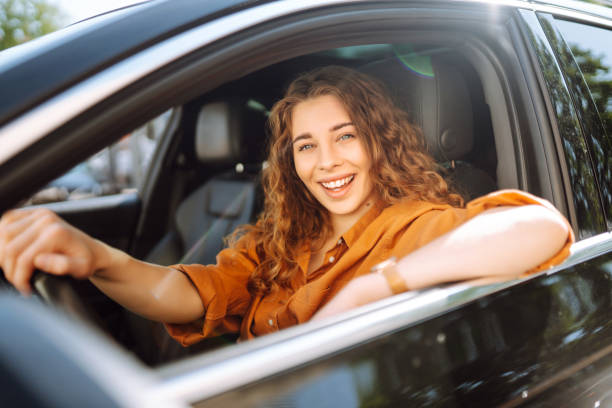 istock Emotional woman drives a car. 1688207426