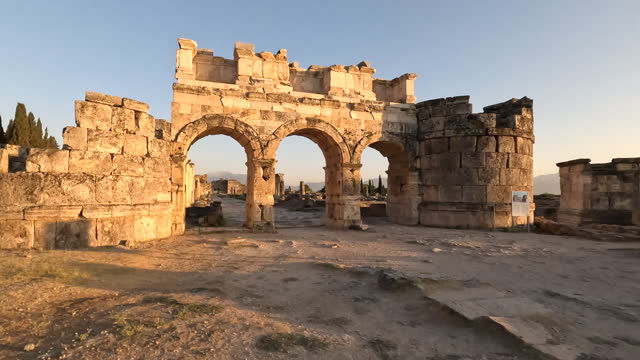 Frontinus Gate and agora of ancient ruins of Hierapolis during sunset in  Pamukkale in Denizli