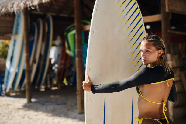 istock Pensive female surfer during summer day on the beach. 1688224411
